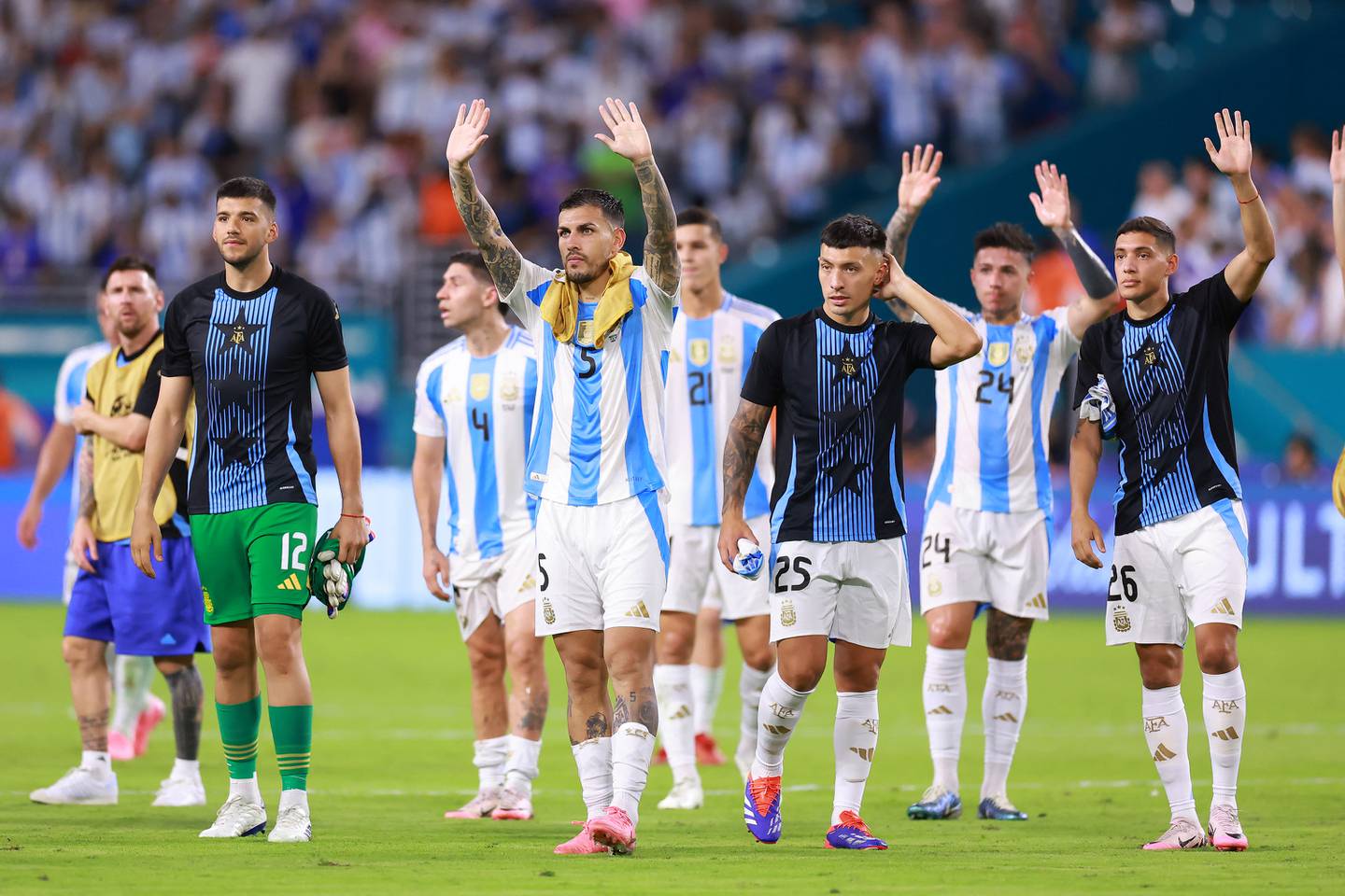 MIAMI GARDENS, FLORIDA - JUNE 29: Leandro Paredes of Argentina (C) and teammates wave to fans as they celebrate the team's victory and progression to the quarter finals after during the CONMEBOL Copa America 2024 Group A match between Argentina and Peru at Hard Rock Stadium on June 29, 2024 in Miami Gardens, Florida.   Hector Vivas/Getty Images/AFP (Photo by Hector Vivas / GETTY IMAGES NORTH AMERICA / Getty Images via AFP)